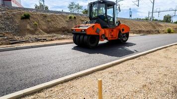 Road construction site with an asphalt compactor machine, highlighting infrastructure development and urban planning concepts photo
