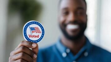 Close up of a happy voter smiling holding an I Voted sticker blurred background photo