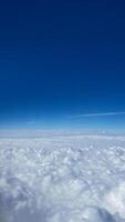A serene view of fluffy white clouds against a vibrant blue sky, embodying concepts of freedom and travel inspiration photo