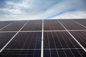 Solar panel on green grass background, Alternative energy from the sun. photo