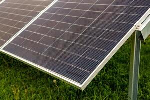 Solar panel on green grass background, Alternative energy from the sun. photo