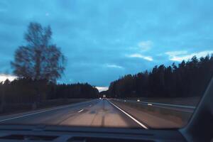 Blurred unfocused view through the moving car windscreen. Glitch retro effect. photo