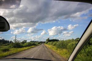 View of forest road through car glass. photo