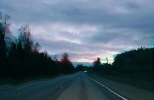 Blurred unfocused view through the moving car windscreen. Glitch retro effect. photo