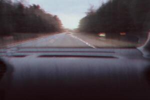Blurred unfocused view through the moving car windscreen. Glitch retro effect. photo