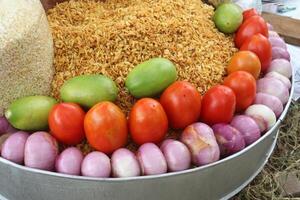 fried flattened rice and chanachur stock with onion, tomato, lemon photo