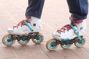 Inline Skates with leg on road photo