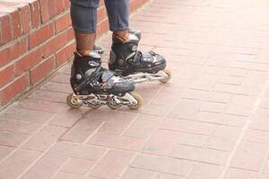 Inline Skates with leg on road photo