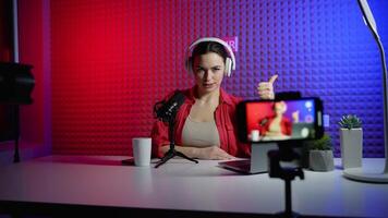 Female blogger recording content for her blog and calls to put likes and subscribe to the channel video