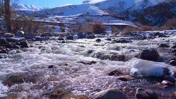Sparkling streams of a mountain river flowing down over rocky cascade in summer video