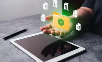 Woman hand on digital tablet for DMS concept. Document Management System. Software to store, organize and manage digital documents. photo