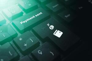 PC keyboard with Payment Sent button. Concept of financial transactions with mobile devices. Closeup photo. Money sent transfer. Shopping online. photo