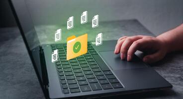 Woman hand on laptop for DMS concept. Document Management System. Software to store, organize and manage digital documents. photo