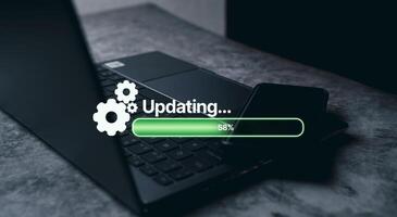 Laptop on desk with virtual installing update bar. Software updates or operating system upgrades. Improved security. photo