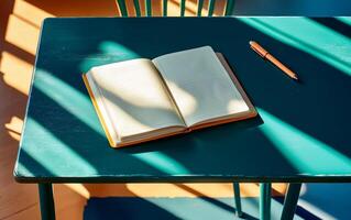 Flat lay green desk view with open notepad, pen and long shadows. Back to school or educational concept. photo