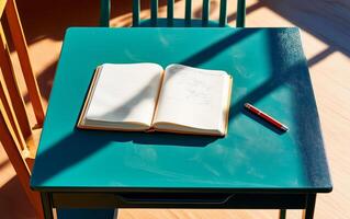 Flat lay green desk view with open notepad, pen and long shadows. Back to school or educational concept. photo