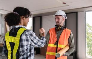 Engineering Team Celebrates Successful Project Completion with Handshake in Modern Office Environment photo