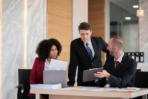 Diverse business team discussing project at office desk, Concept of teamwork photo