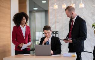 Diverse business team reviewing documents at office desk, Concept of teamwork photo