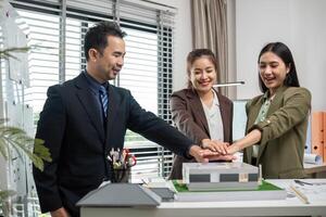 Business Team Collaborating on Real Estate Project Planning in Modern Office Setting with Architectural Model photo