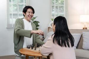 Mother and Son Enjoying Quality Time Playing Chess Together in a Cozy Modern Living Room photo