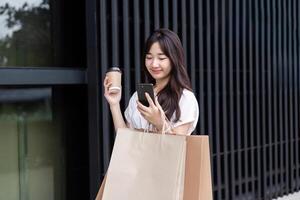 Young Woman Shopping with Paper Bag at Department Store, Smiling and Holding Coffee, Modern Lifestyle and Retail Experience photo
