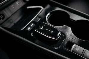 Modern car center console with electronic gear selector, stylish design, and control buttons. Ideal for automotive content, advertising, and blogs, highlighting comfort and technology photo