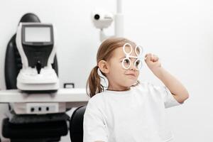 A young girl is practicing her vision skills in a state-of-the-art ophthalmology clinic. Engaging tools and a friendly atmosphere make the experience both fun and beneficial for her development photo