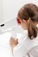 A young girl engages in orthoptic and pleoptic therapy using advanced vision stimulation equipment. Laser eye treatment promotes recovery and enhances vision in a soothing environment photo