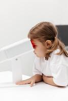 A young girl engages in orthoptic and pleoptic therapy using advanced vision stimulation equipment. Laser eye treatment promotes recovery and enhances vision in a soothing environment photo