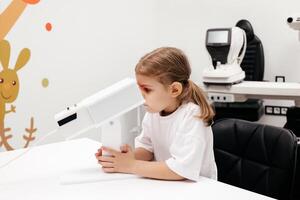 A young girl engages in orthoptic and pleoptic therapy using advanced vision stimulation equipment. Laser eye treatment promotes recovery and enhances vision in a soothing environment photo