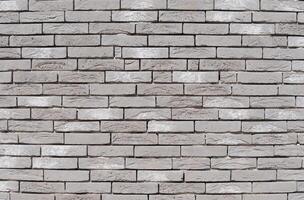 Gray textured brick wall, long and narrow modern bricks, horizontal decorative masonry, Textured stone background, brickwork outside new building, photo