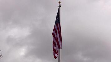 United States Flag On Flagpole With Gray Clouds Moving In Background Overcast Sky Sped Up video