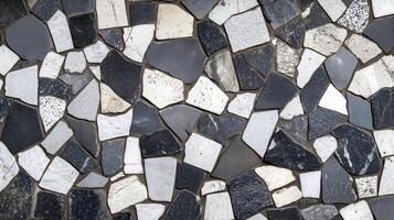 A black and white mosaic tile pattern. The tiles are of different sizes and shapes. photo