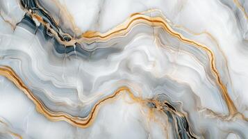 A marble wall with gold and gray swirls. The gold and gray swirls are very prominent and the marble is very shiny. photo