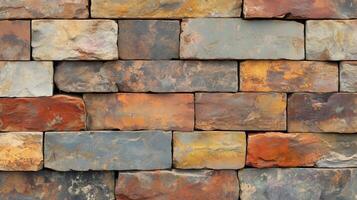 A brick wall with a variety of colors and textures. The wall is made up of many different colored bricks. photo