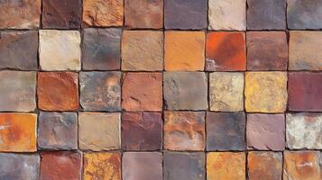 A brick wall with a variety of colors and textures. The wall is made up of many different colored bricks. photo