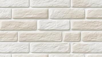 A white brick wall with a tan brick border. The wall is made of white and tan bricks. photo