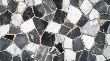 A black and white mosaic tile pattern. The tiles are of different sizes and shapes. photo