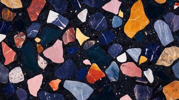 A mosaic made of colorful rocks and stones. The colors are bright and the stones are of various sizes. photo