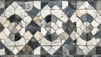 A black and white mosaic tile pattern. The tiles are of different sizes and shapes. photo