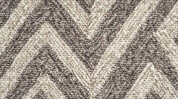 A piece of fabric with a zigzag pattern. The fabric is black and white. The zigzag pattern is very prominent and the fabric is very soft. photo