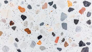 A mosaic tile floor with a variety of colored stones. The tiles are arranged in a pattern that creates a sense of depth and texture. photo