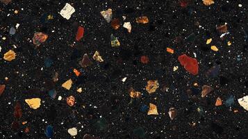 A black and brown mosaic tile floor with a variety of different colored stones. photo