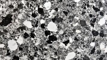 A close up of a stone wall with a grey and white color scheme. The stone is rough and jagged. photo