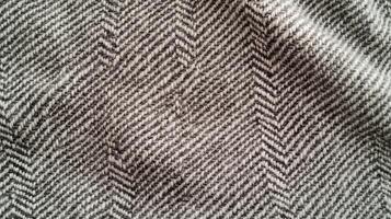 A piece of fabric with a zigzag pattern. The fabric is black and white. The zigzag pattern is very prominent and the fabric is very soft. photo