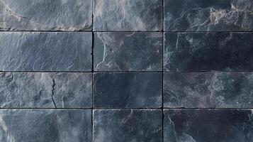 A black and brown tile with a rustic look. The tiles are square and are laid out in a row. photo