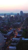 Evening falling on the gorgeous New York. Beautiful metropolis panorama with appearing lights. Hazy horizon at backdrop. Vertical video