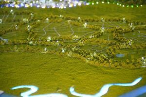 A photo of a miniature solar power plant in the middle of a green plain