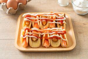 flat pancake roll with sausage and crab stick photo
